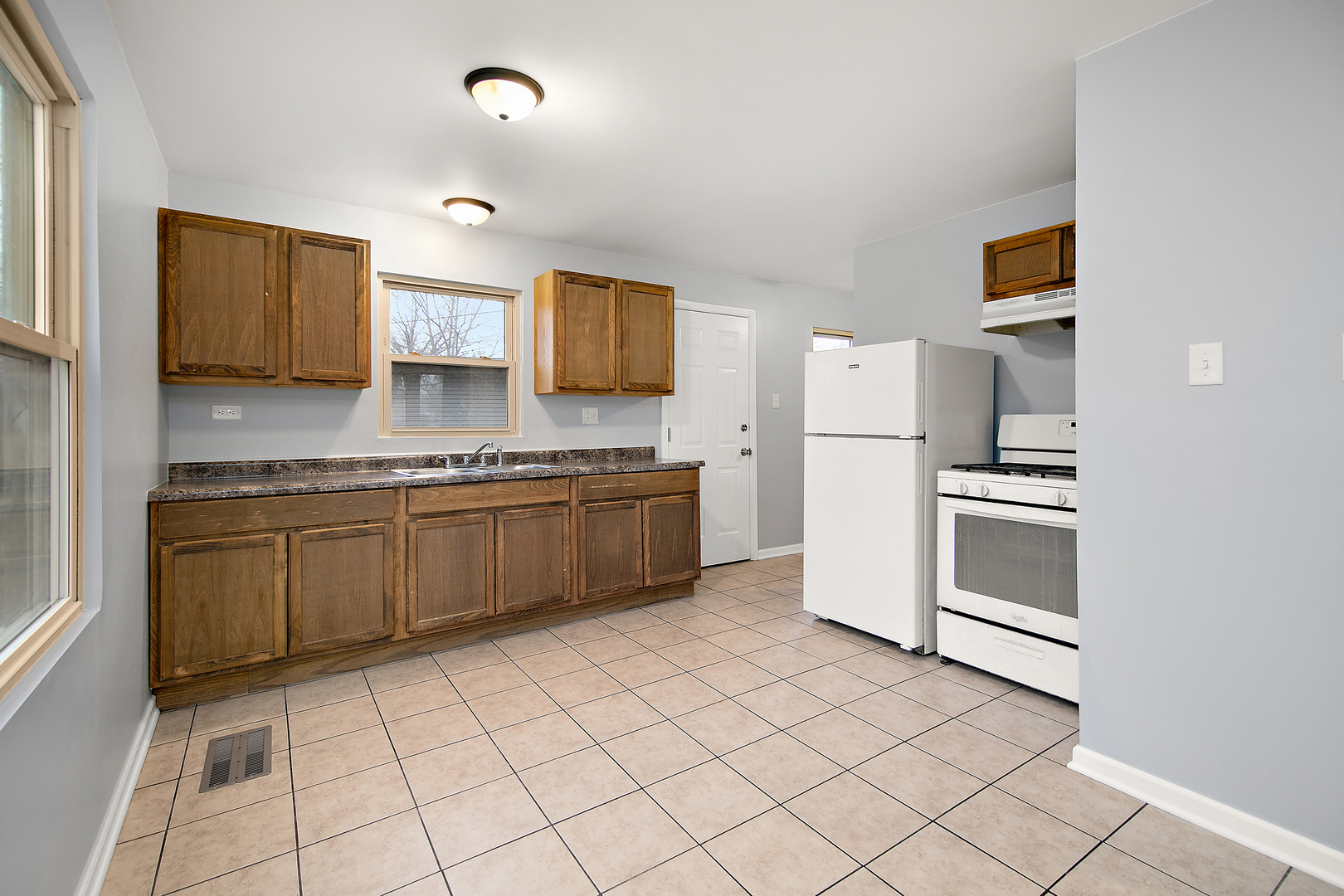 310 Nassau Street Park Forest, IL 60466 - Photo 7 of 19 a kitchen with stainless steel appliances a refrigerator sink and microwave