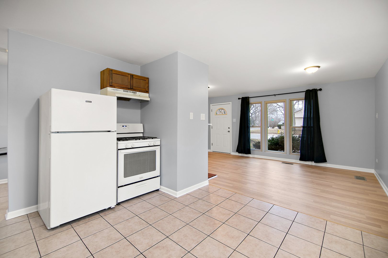 310 Nassau Street Park Forest, IL 60466 - Photo 9 of 19 a kitchen with a refrigerator a stove top oven and cabinets