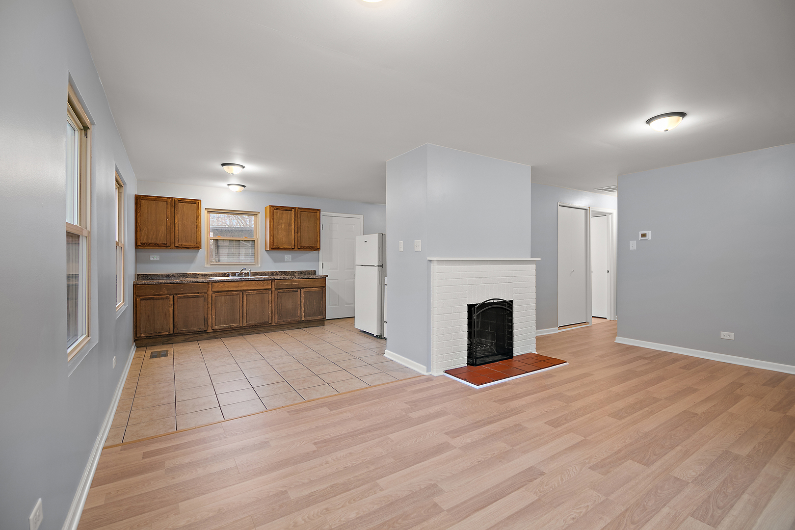 310 Nassau Street Park Forest, IL 60466 - Photo 10 of 19 a view of a livingroom with a fireplace a ceiling fan and windows