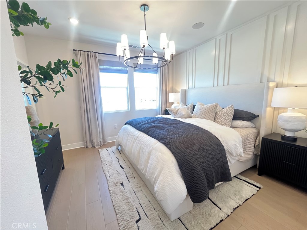 1872 Union, Unit 25 Anaheim, CA 92805 - Photo 16 of 41 a spacious bedroom with a bed and a chandelier