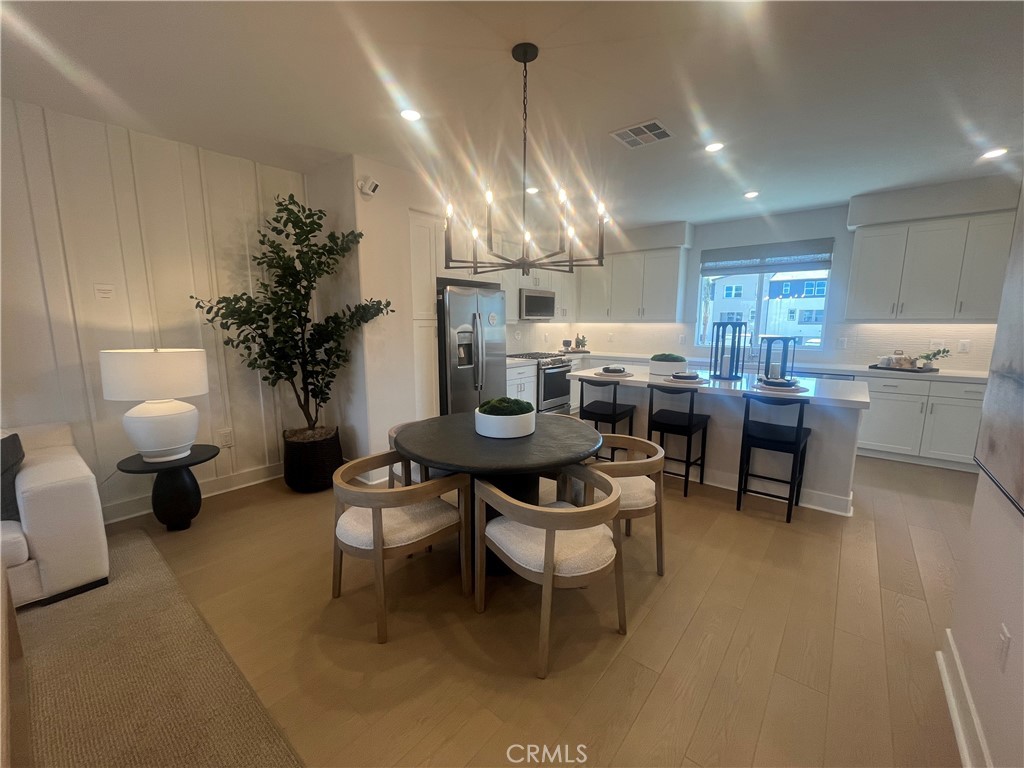 1872 Union, Unit 25 Anaheim, CA 92805 - Photo 7 of 41 a dining room with furniture a chandelier and kitchen view