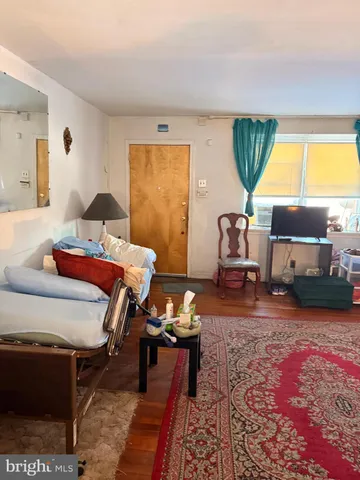 a bedroom with furniture and a large window