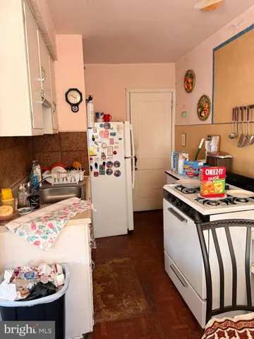 a kitchen with a refrigerator and a stove