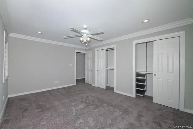 an empty room with closet and a window