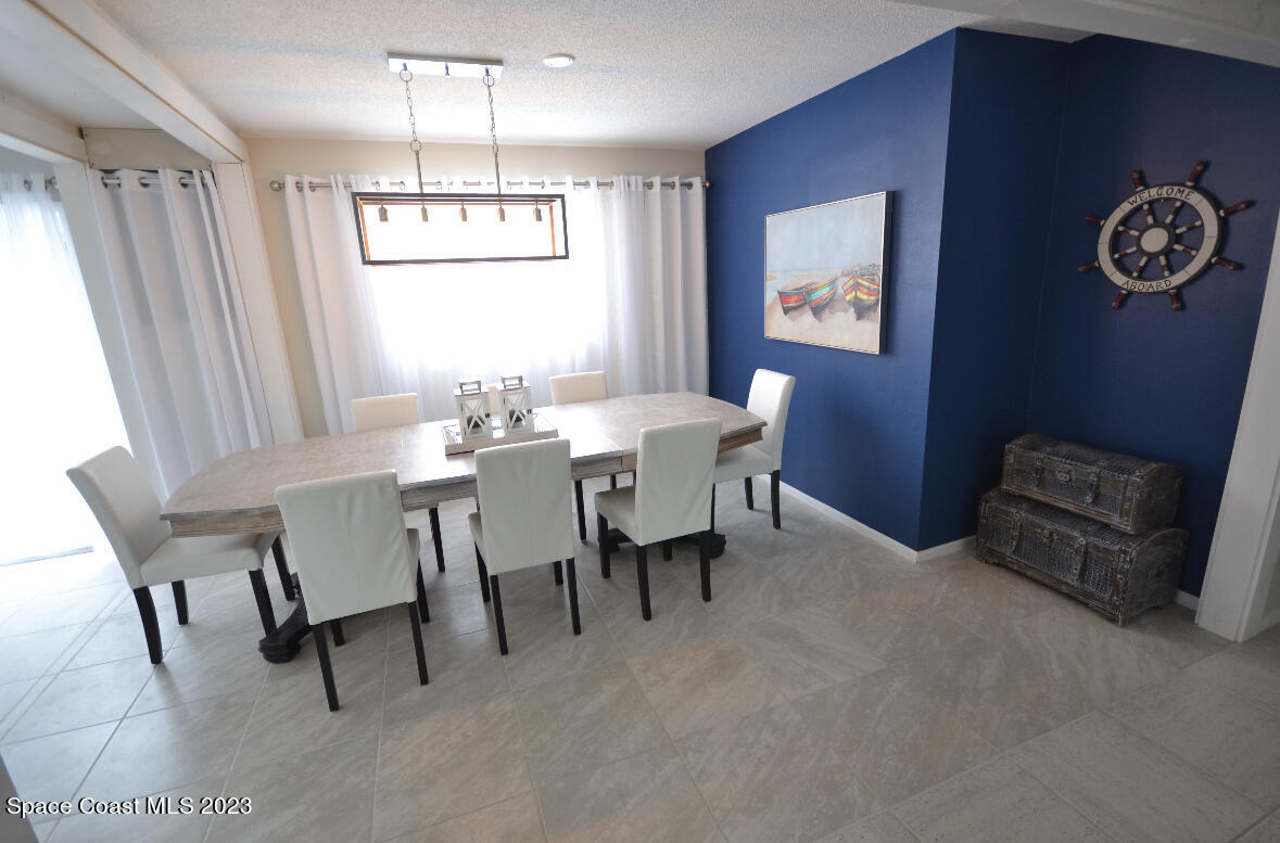 2785 Locksley Road Melbourne, FL 32935 - Photo 25 of 34 a view of a dining room with furniture window and outside view