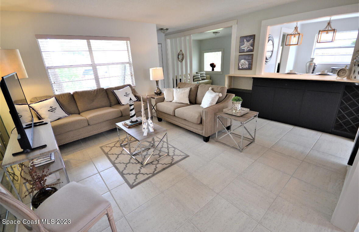 2785 Locksley Road Melbourne, FL 32935 - Photo 26 of 34 a living room with furniture and a large window