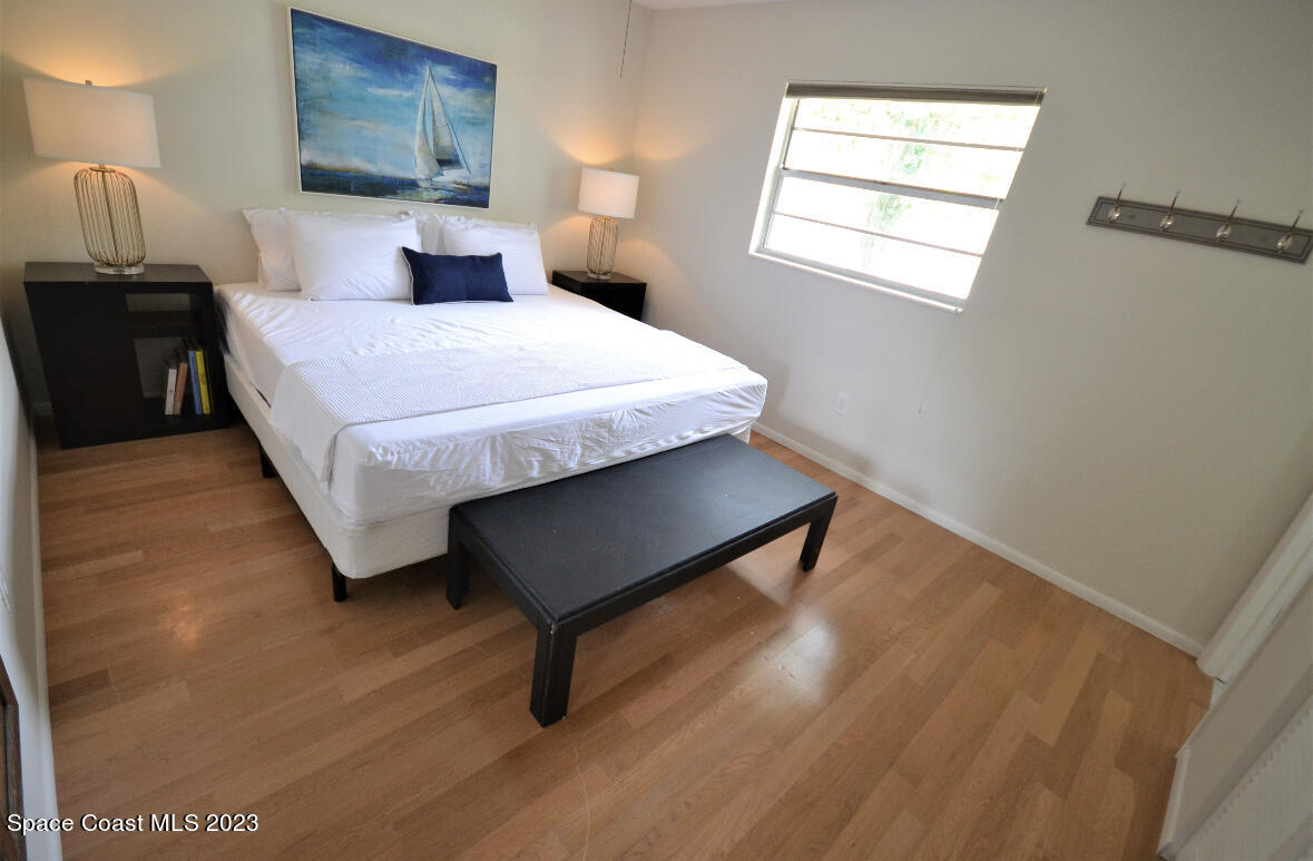 2785 Locksley Road Melbourne, FL 32935 - Photo 29 of 34 a bedroom with a bed and wooden floor