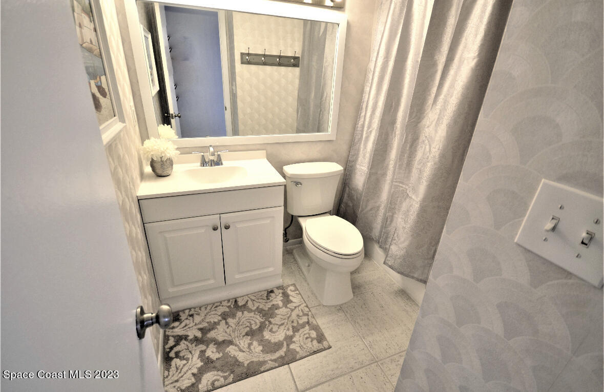 2785 Locksley Road Melbourne, FL 32935 - Photo 32 of 34 a bathroom with a sink toilet and window