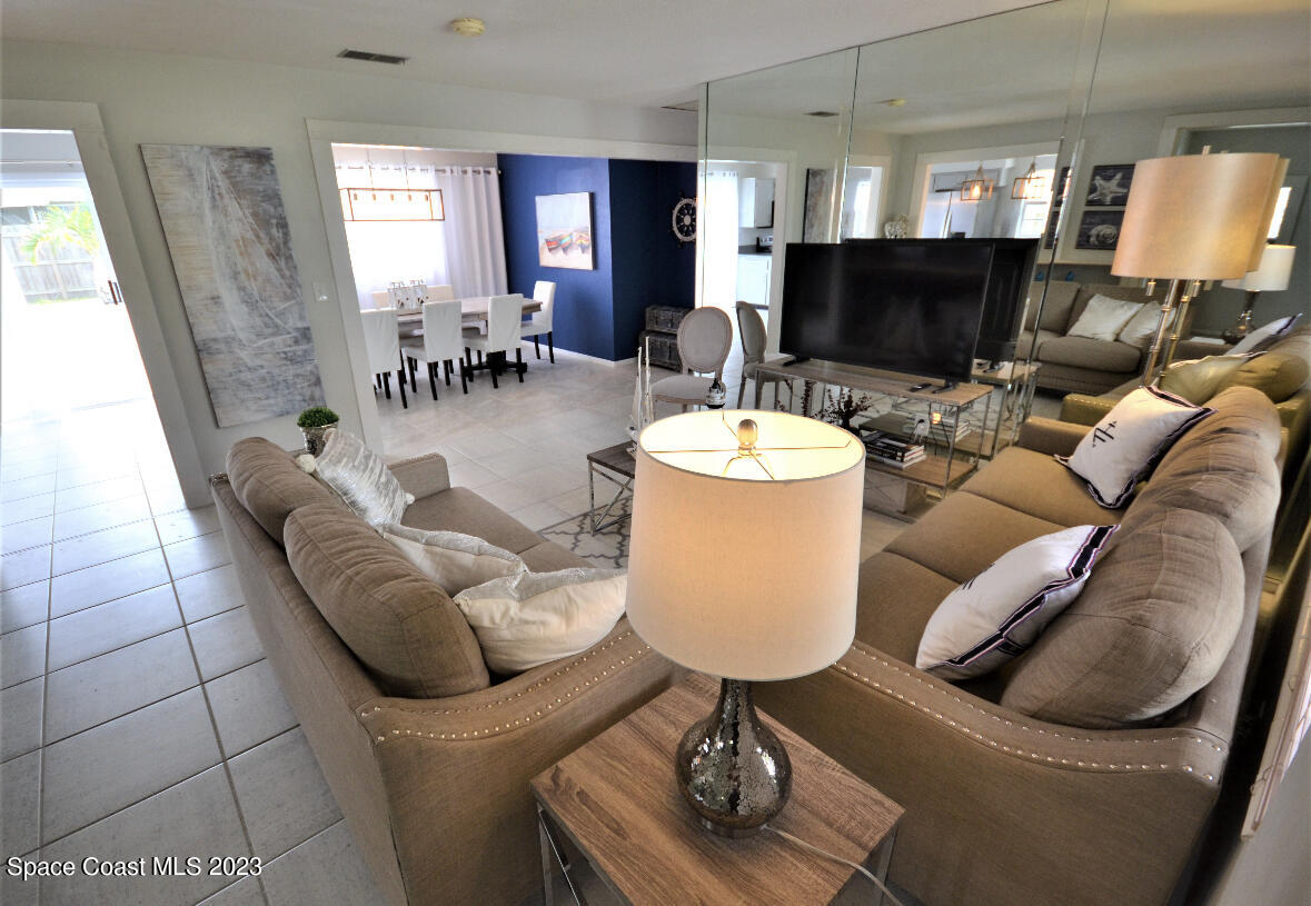 2785 Locksley Road Melbourne, FL 32935 - Photo 4 of 34 a living room with furniture and a table