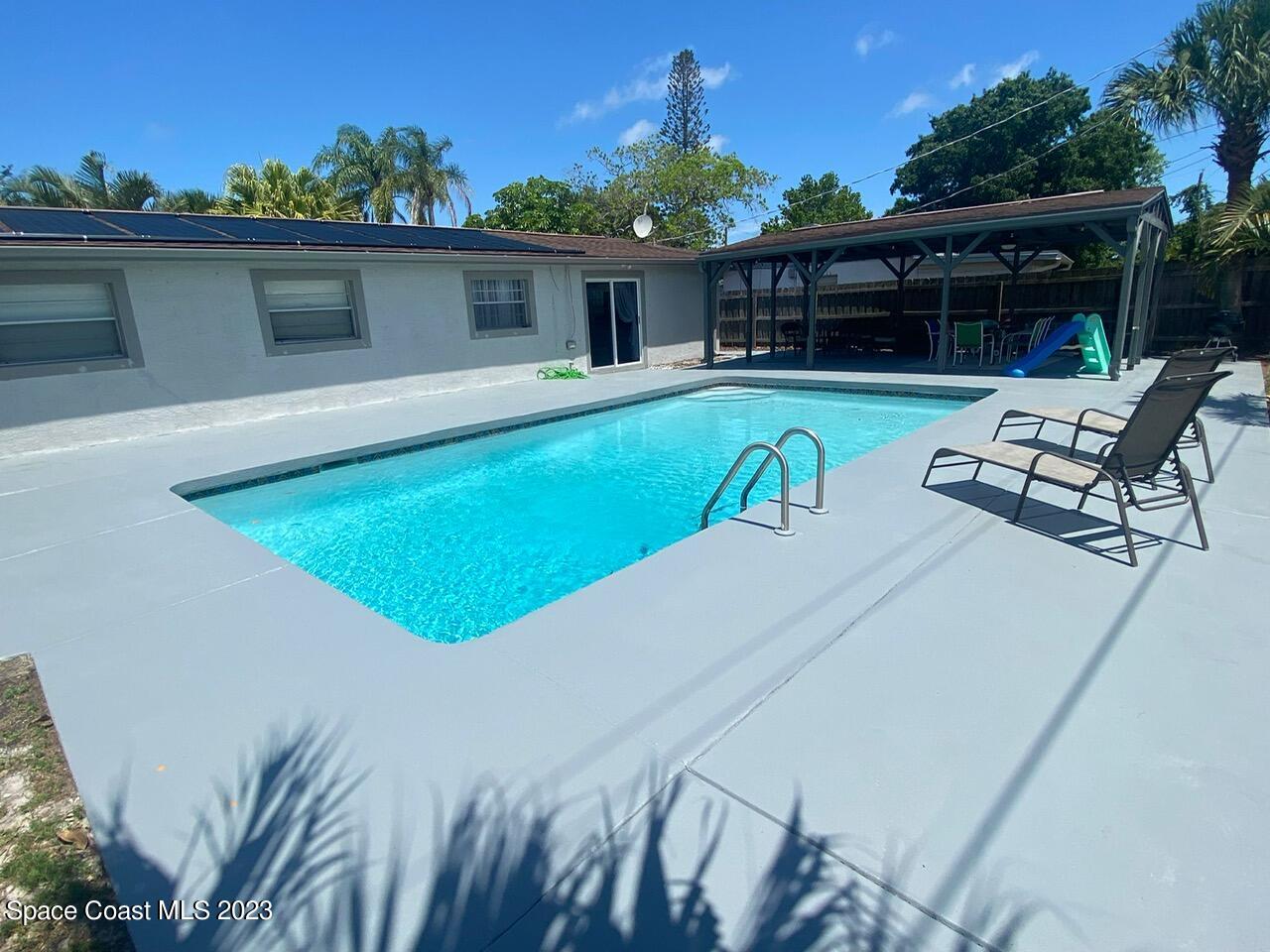 2785 Locksley Road Melbourne, FL 32935 - Photo 8 of 34 a view of a patio with chairs and potted plants