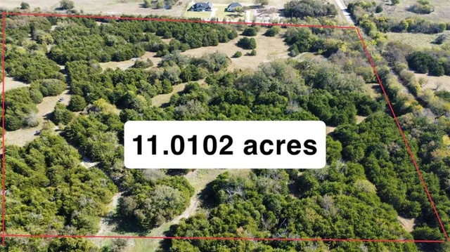 a sign broad in front of the red and white house