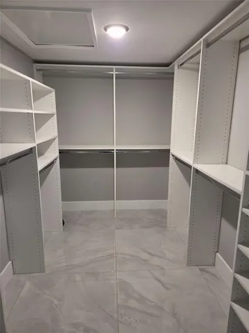 a bathroom with a granite countertop sink a mirror and vanity