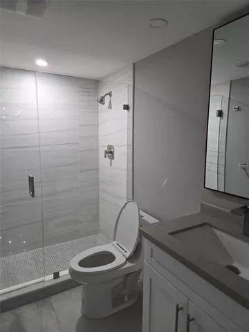 en empty room with windows and fan