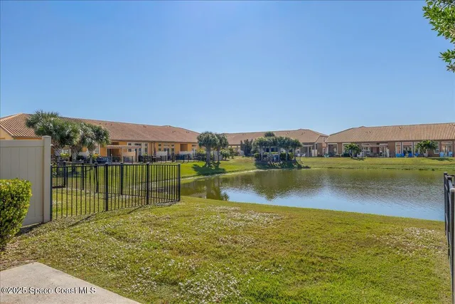 a view of swimming pool with outdoor seating and city in back
