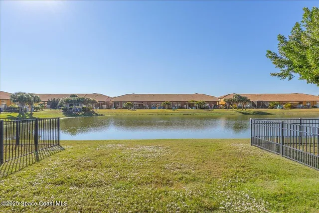 a living room with furniture a bookshelf and a large window