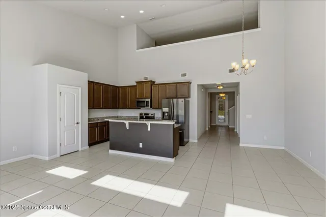 a kitchen with granite countertop a refrigerator and a sink