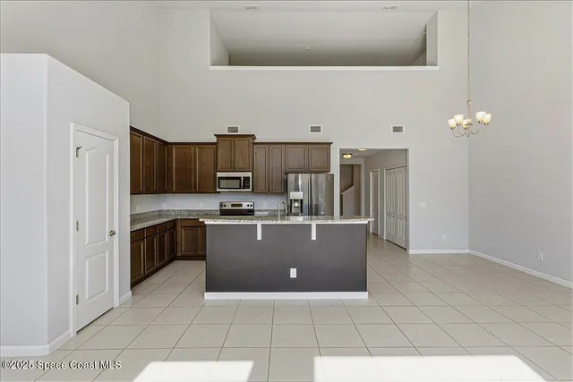 a kitchen with a sink a counter top space and appliances