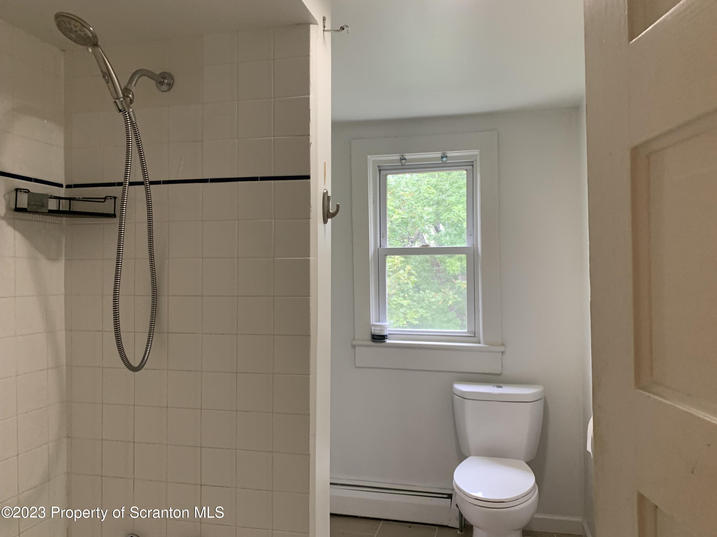 1210 1212 Hampton Street Scranton, PA 18504 - Photo 15 of 17 a bathroom with a toilet a sink and a shower
