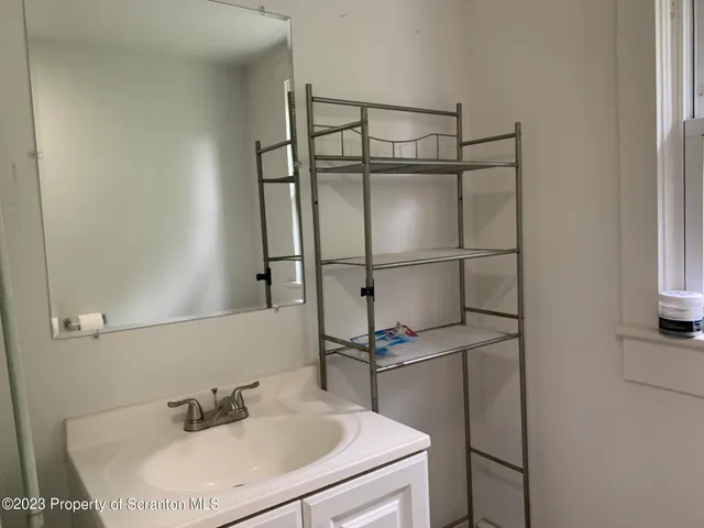 a bathroom with a sink and mirror