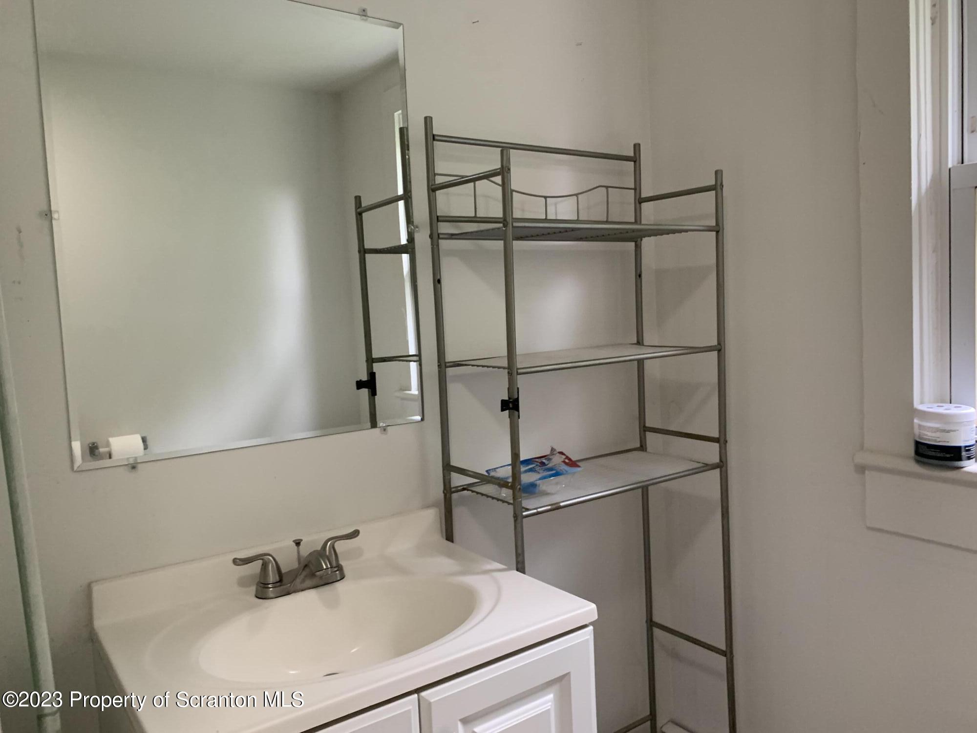 1210 1212 Hampton Street Scranton, PA 18504 - Photo 16 of 17 a bathroom with a sink and mirror