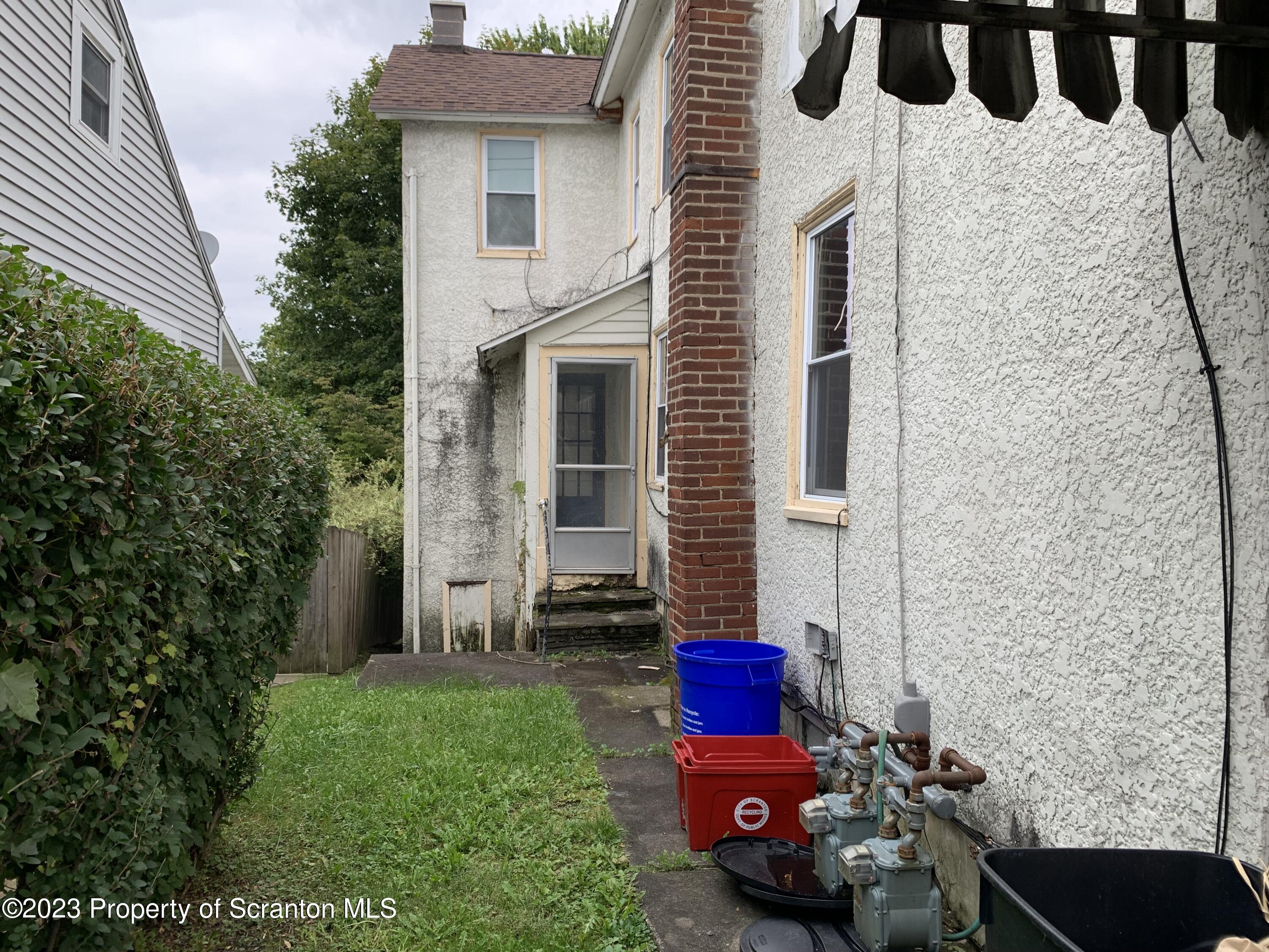 1210 1212 Hampton Street Scranton, PA 18504 - Photo 2 of 17 a view of a chair and table in backyard of the house