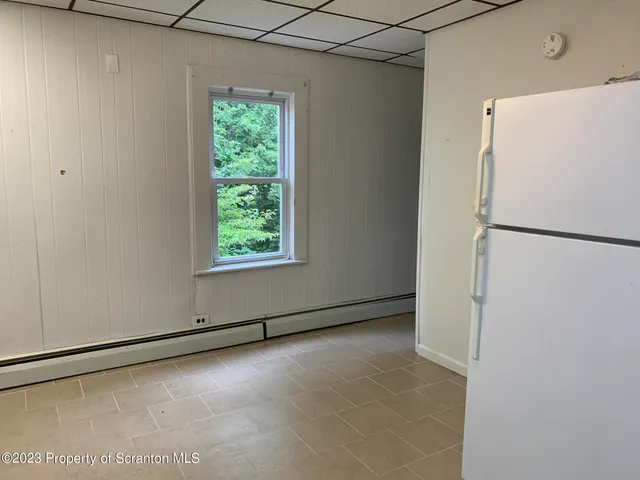 a view of a refrigerator in a kitchen