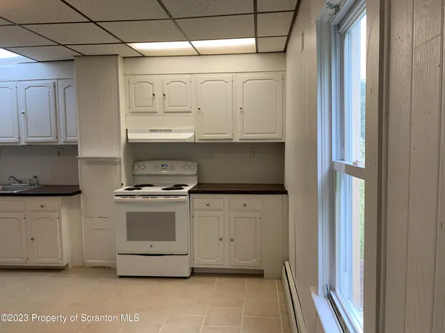 a kitchen with stainless steel appliances granite countertop a stove and a refrigerator