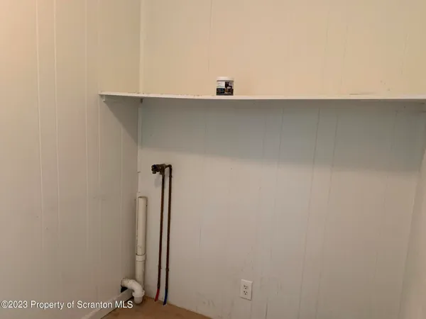 a view of a closet with wooden floor