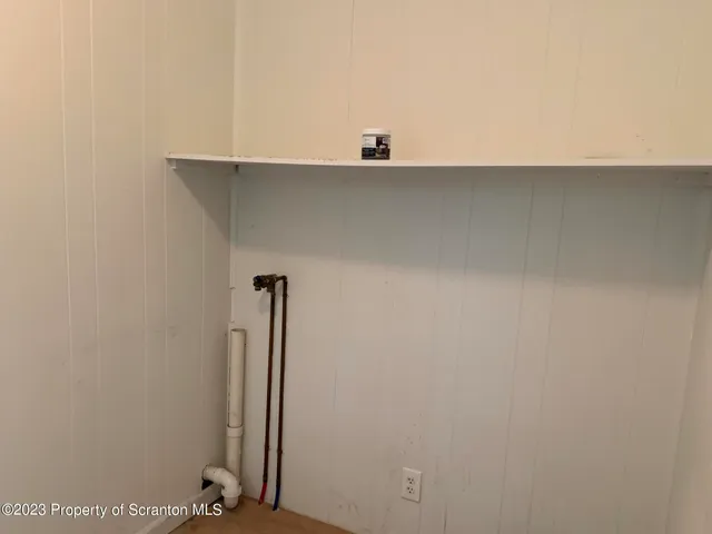 a view of a closet with wooden floor