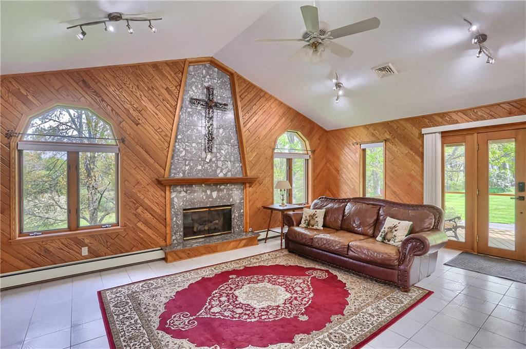 481 Chicora Fenelton Road Chicora, PA 16025 - Photo 18 of 50 Family room with vaulted wood-accent ceiling, fireplace focal point, and walls of natural light.