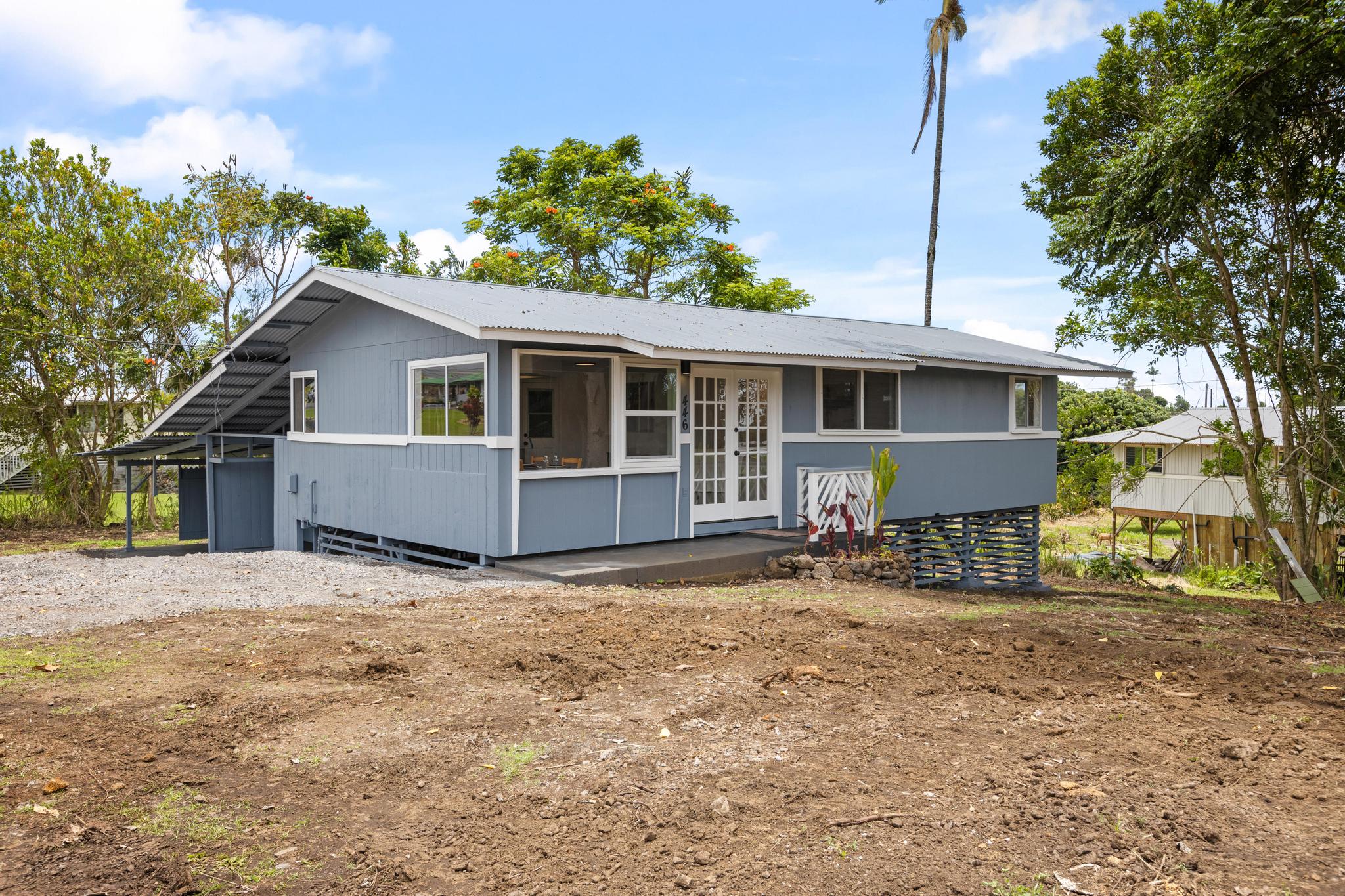 a view of a house with a yard and sitting area