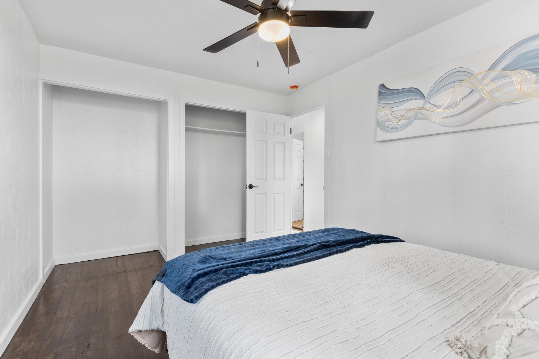 446 Ainaola Drive Hilo, HI 96720 - Photo 15 of 30 a bedroom with a bed and a chandelier