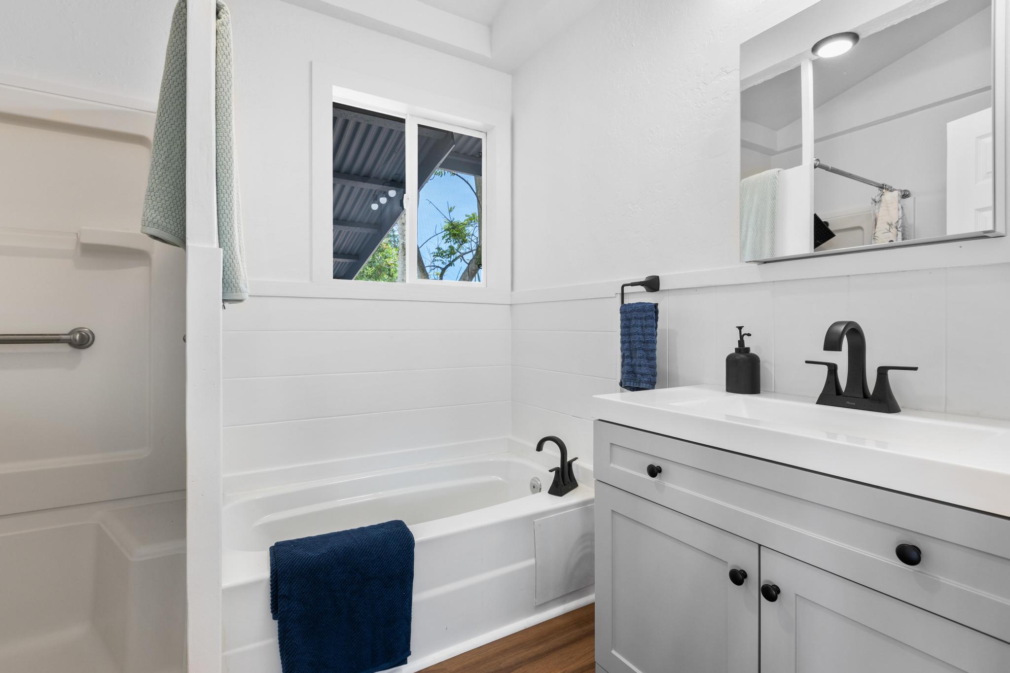 446 Ainaola Drive Hilo, HI 96720 - Photo 16 of 30 a bathroom with a bathtub sink and mirror
