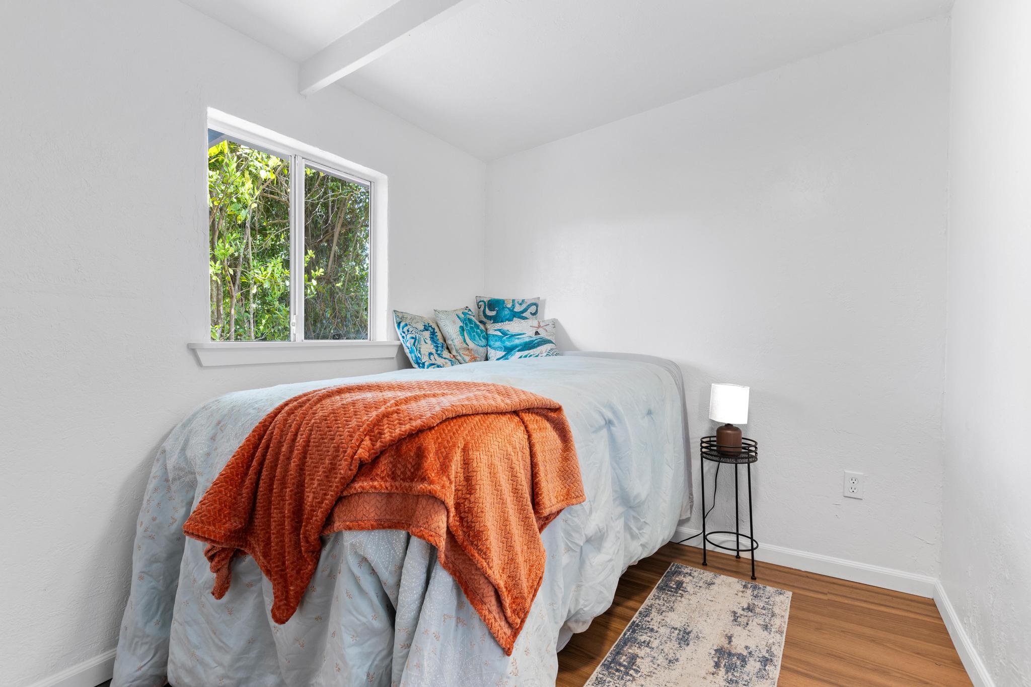 446 Ainaola Drive Hilo, HI 96720 - Photo 23 of 30 a bed sitting in a bedroom next to a window