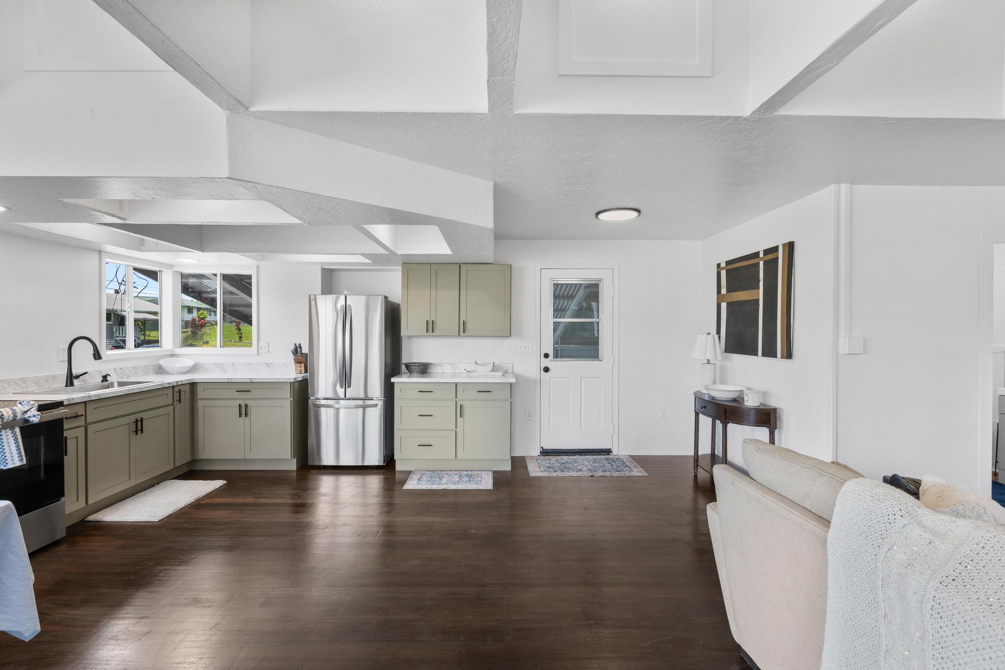 446 Ainaola Drive Hilo, HI 96720 - Photo 3 of 30 a large white kitchen with a lot of counter space and wooden floor