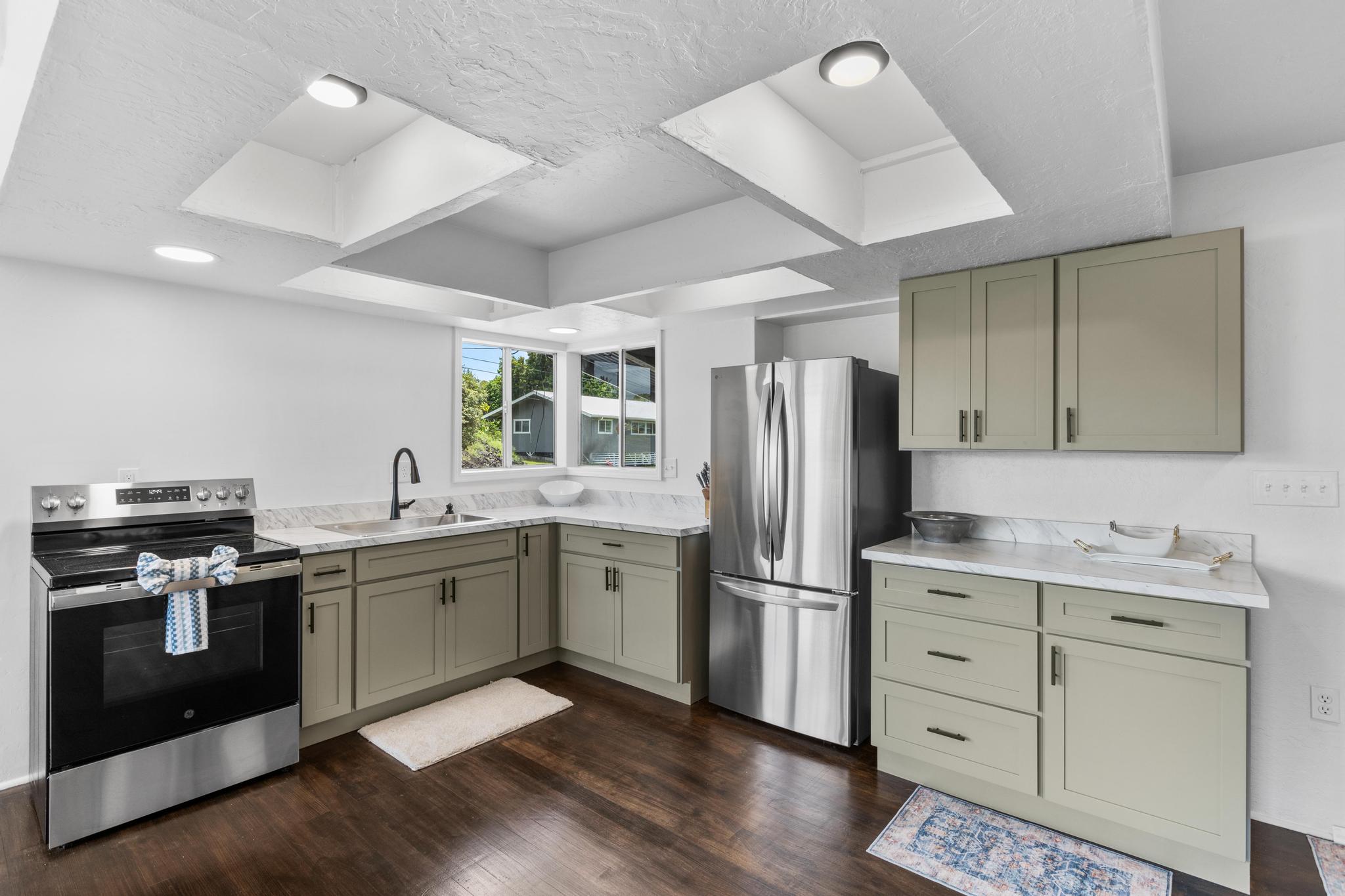 446 Ainaola Drive Hilo, HI 96720 - Photo 4 of 30 a kitchen with a sink stove and refrigerator