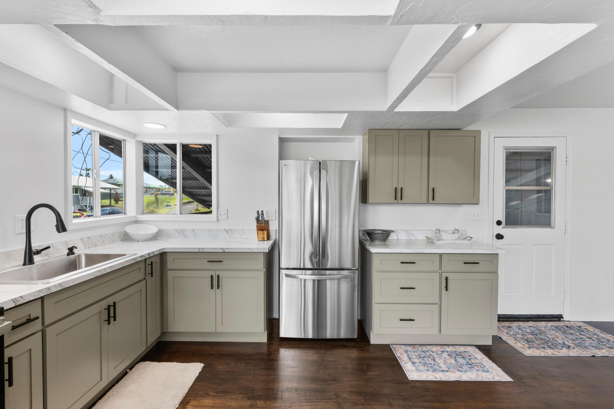 446 Ainaola Drive Hilo, HI 96720 - Photo 6 of 30 a kitchen with a sink stainless steel appliances and cabinets