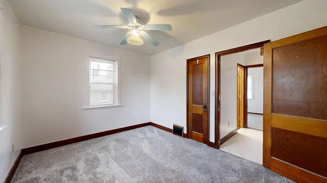 an empty room with windows and closet