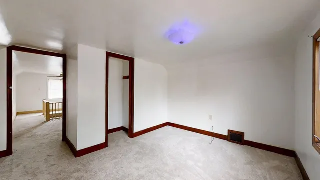 an empty room with a empty space and windows