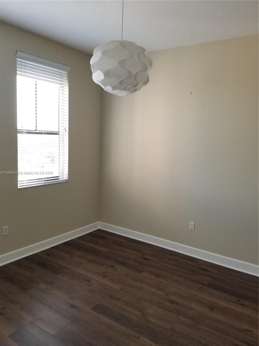 55 Merrick Way, Unit 828 Coral Gables, FL 33134 - Photo 12 of 17 wooden floor in an empty room with a window