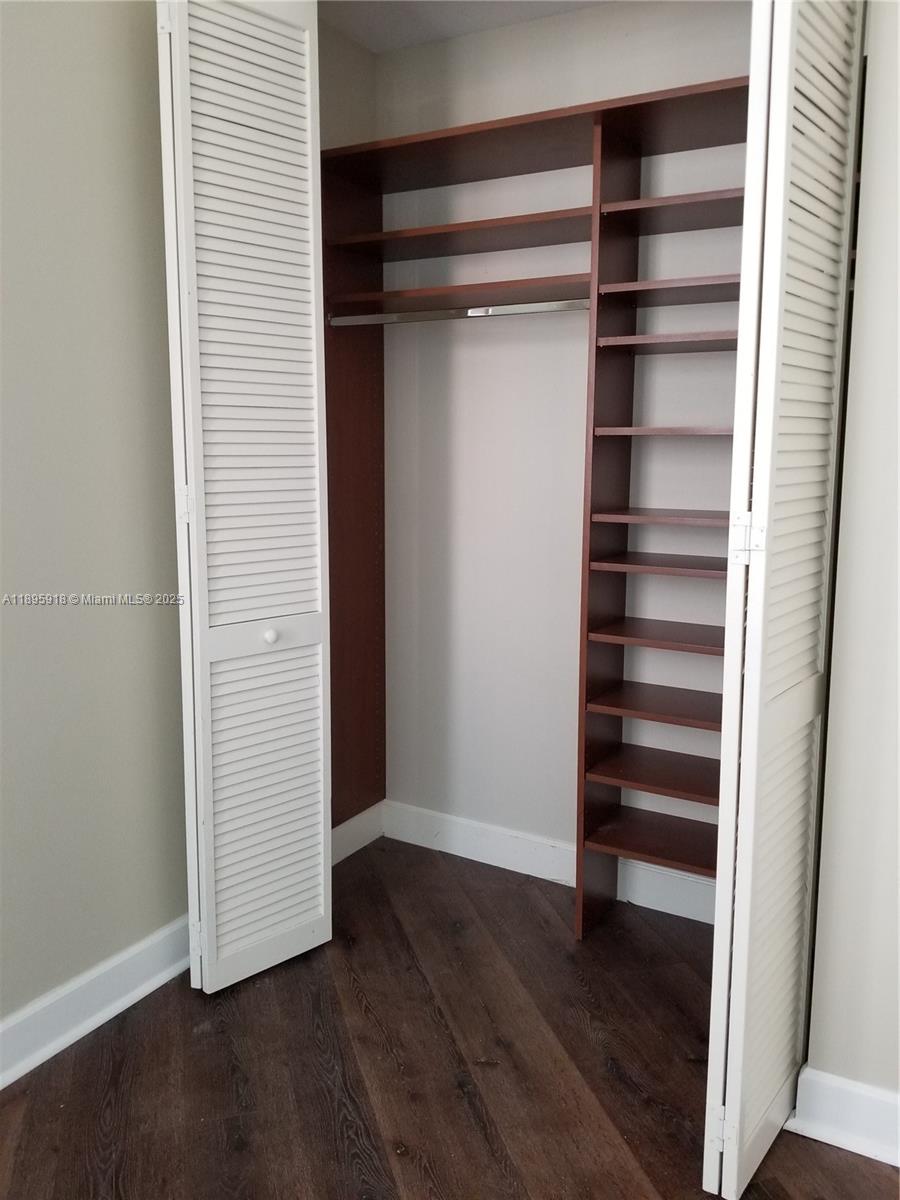 55 Merrick Way, Unit 828 Coral Gables, FL 33134 - Photo 14 of 17 a view of walk in closet with empty racks