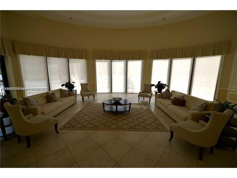 55 Merrick Way, Unit 828 Coral Gables, FL 33134 - Photo 16 of 17 a living room with furniture and a large window