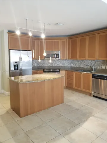 a kitchen with stainless steel appliances granite countertop a sink and cabinets
