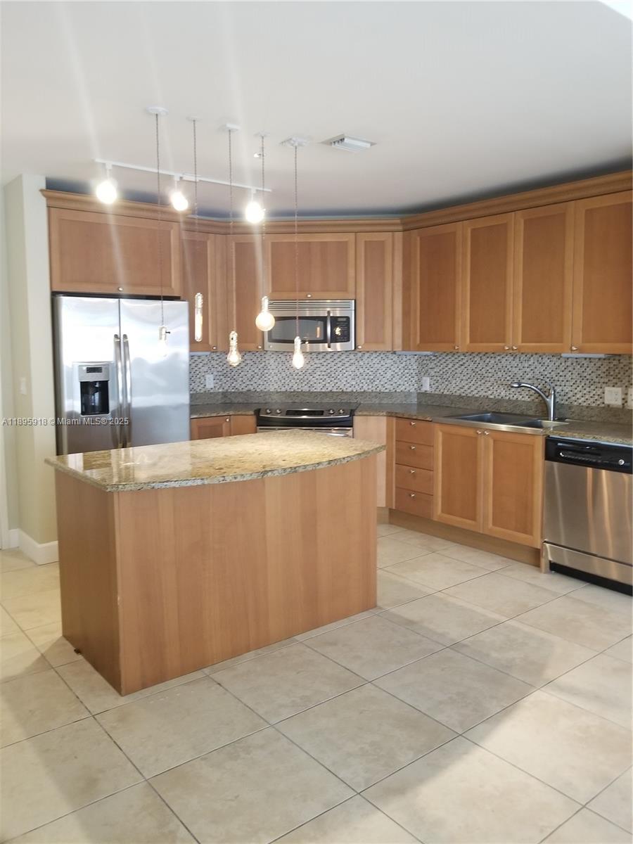 55 Merrick Way, Unit 828 Coral Gables, FL 33134 - Photo 2 of 17 a kitchen with stainless steel appliances granite countertop a sink and cabinets