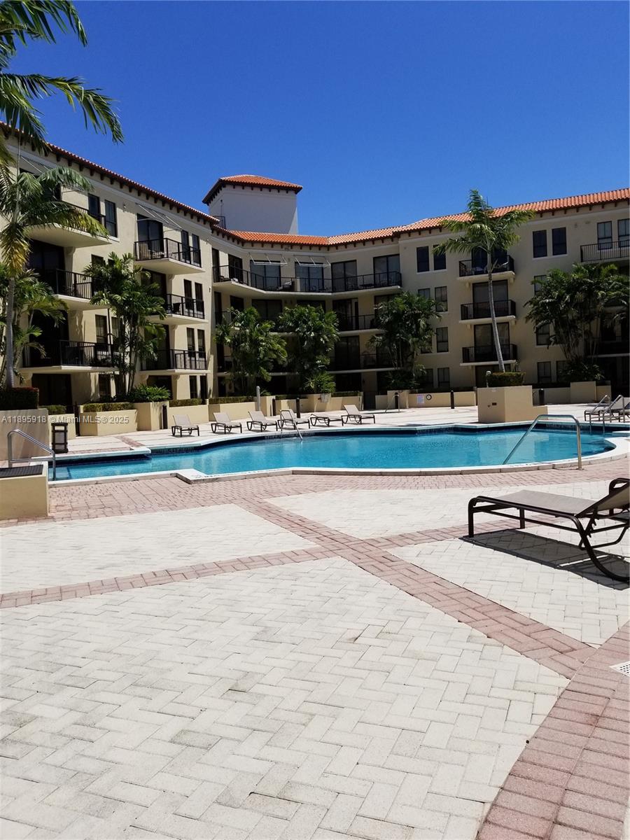 55 Merrick Way, Unit 828 Coral Gables, FL 33134 - Photo 3 of 17 a view of swimming pool with outdoor seating