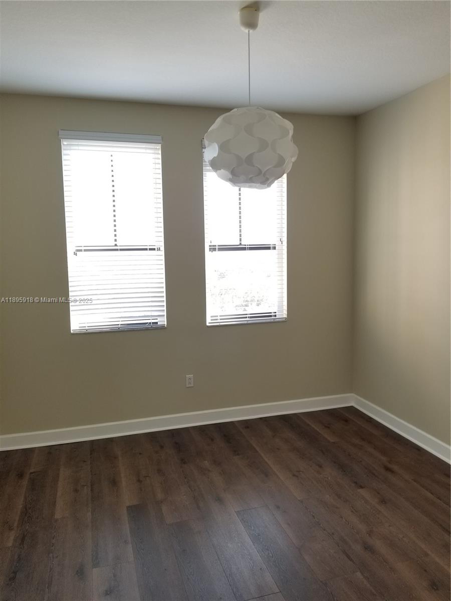 55 Merrick Way, Unit 828 Coral Gables, FL 33134 - Photo 8 of 17 wooden floor in an empty room with a window