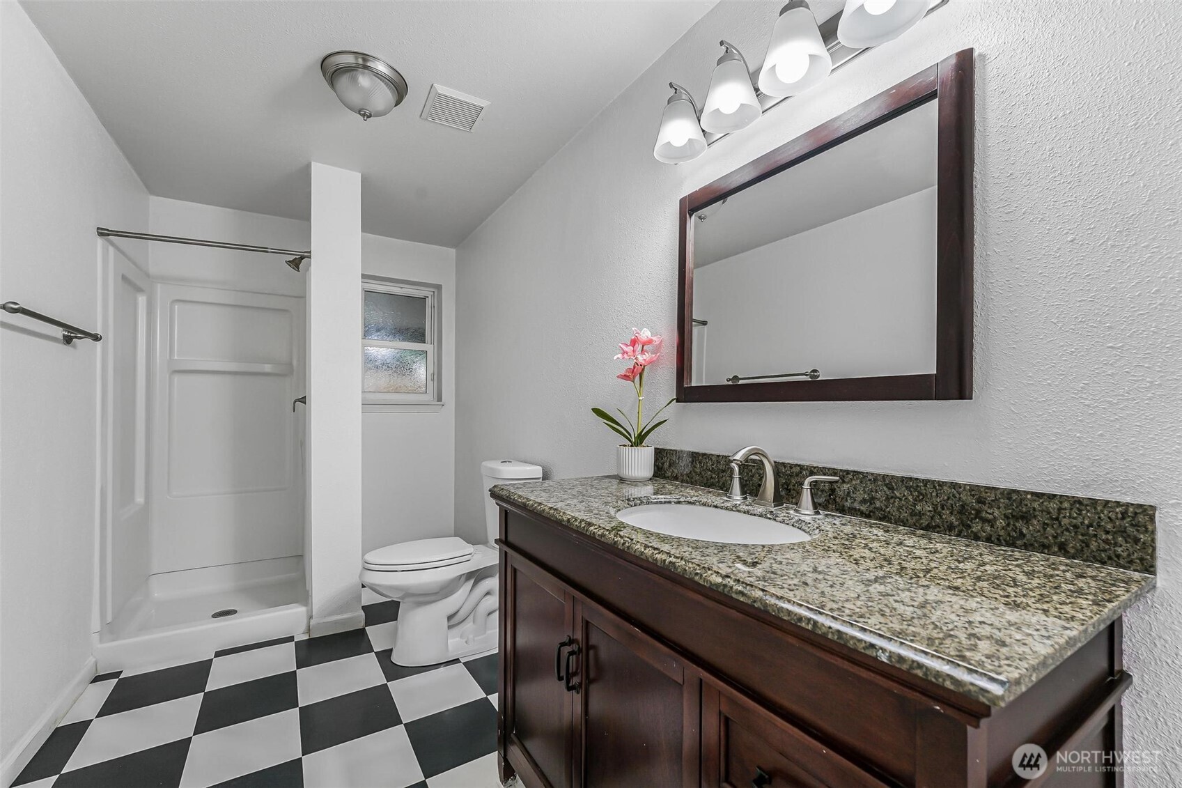 11404 Karshner Road East Edgewood, WA 98372 - Photo 29 of 40 a bathroom with a sink a toilet a mirror and shower