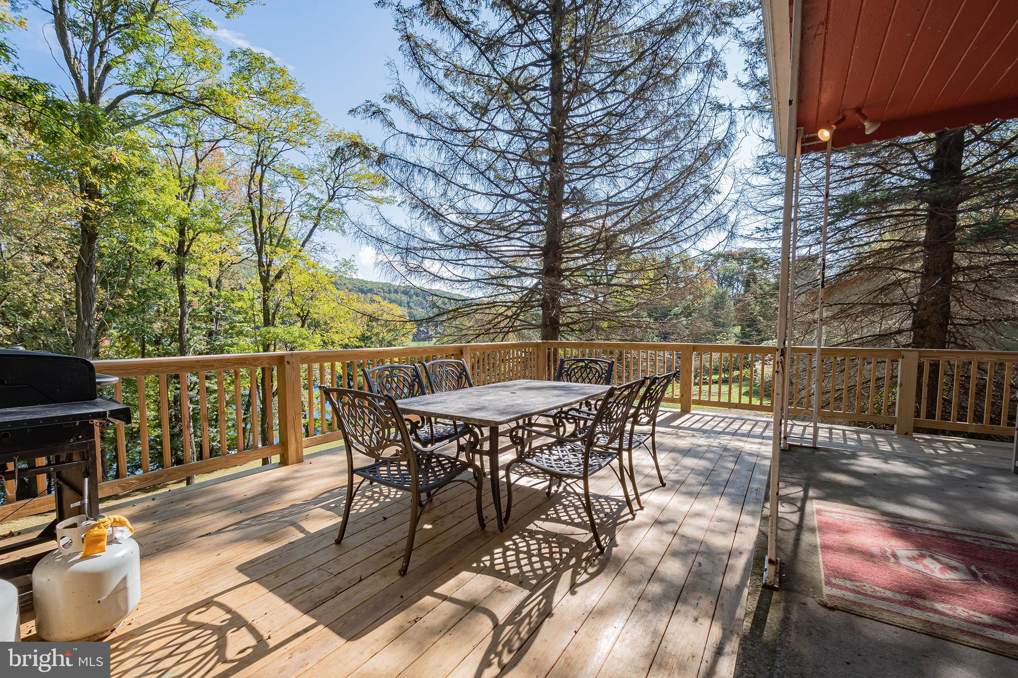 1417 Marsh Hill Road McHenry, MD 21541 - Photo 24 of 34 a view of a roof deck with table and chairs and wooden floor