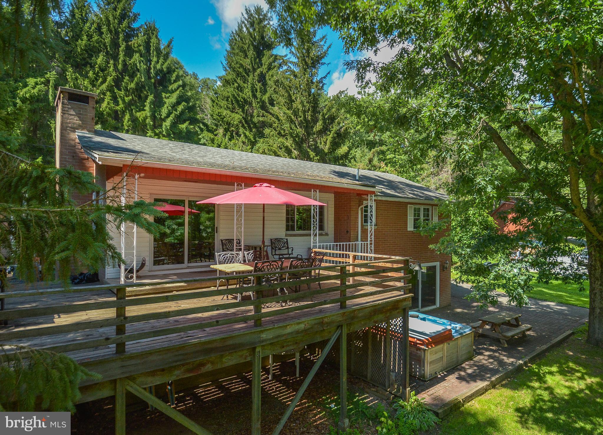 1417 Marsh Hill Road McHenry, MD 21541 - Photo 31 of 34 a view of backyard with table and chairs under an umbrella