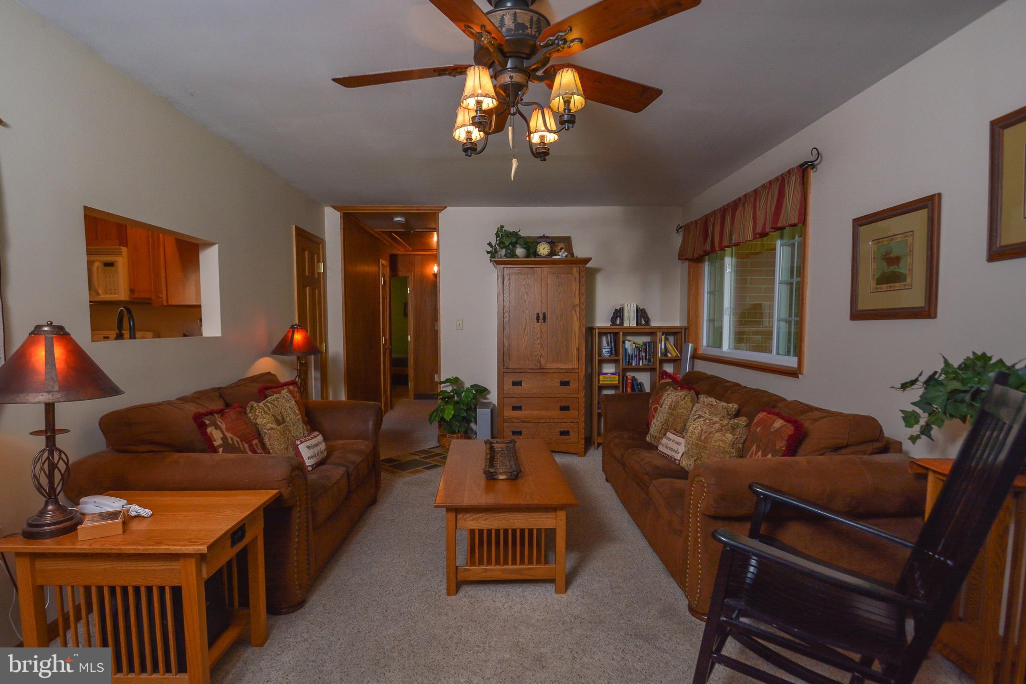 1417 Marsh Hill Road McHenry, MD 21541 - Photo 4 of 34 a living room with furniture a chandelier and a dining room